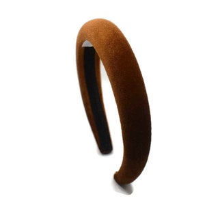 May include: A brown velvet headband with a black elastic band.