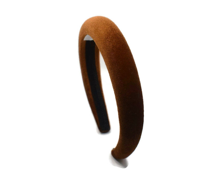 May include: A brown velvet headband with a black elastic band.