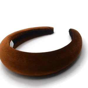 May include: A brown velvet headband with a wide, cushioned band.