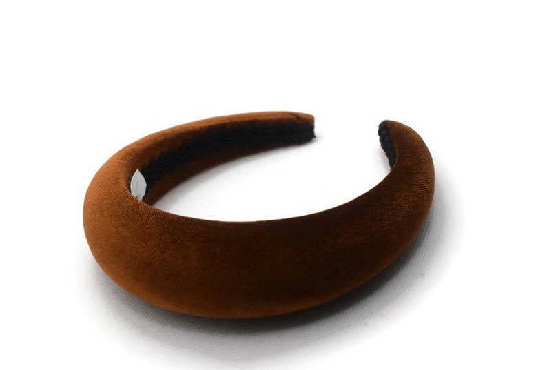 May include: A brown velvet headband with a wide, cushioned band.