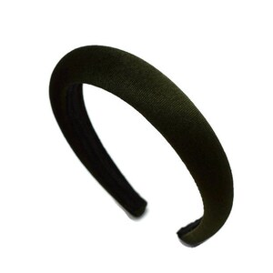 May include: A dark green velvet headband. The headband is wide and has a simple design.