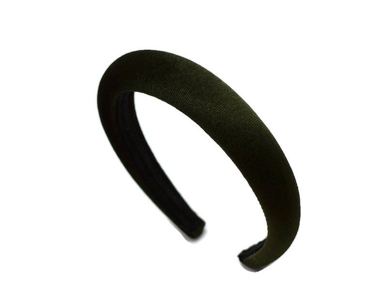 May include: A dark green velvet headband. The headband is wide and has a simple design.