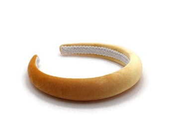 May include: A wide, yellow velvet headband with a white elastic band.