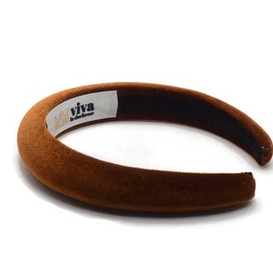 May include: A brown velvet headband with a white label that says "viva la difference".