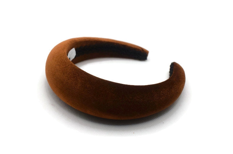 May include: A wide, rounded brown velvet headband.