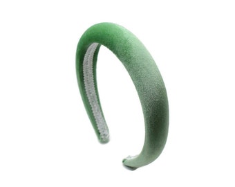 May include: A green velvet headband with a white elastic band.