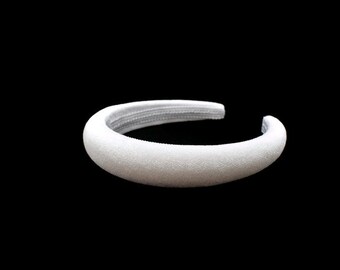 May include: A white padded headband for hair.