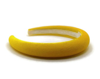 May include: A yellow velvet headband with a white elastic band.