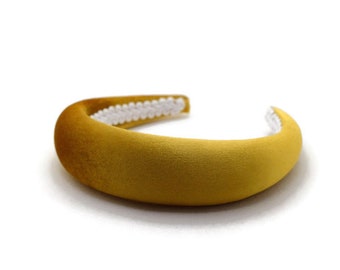 May include: A wide, mustard yellow velvet headband with a white elastic band.