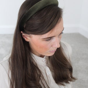 May include: A dark green velvet headband for women's hair.