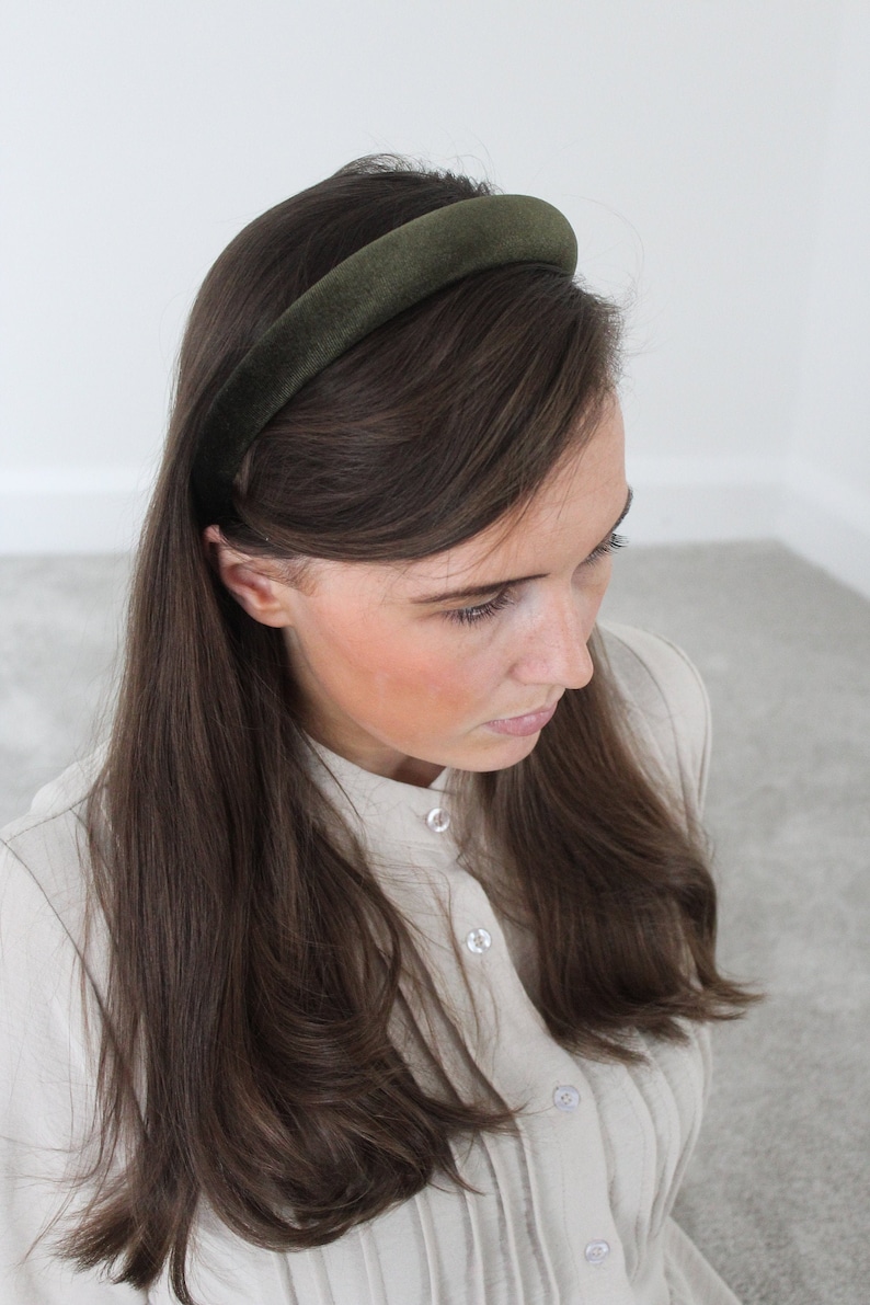 May include: A dark green velvet headband for women's hair.