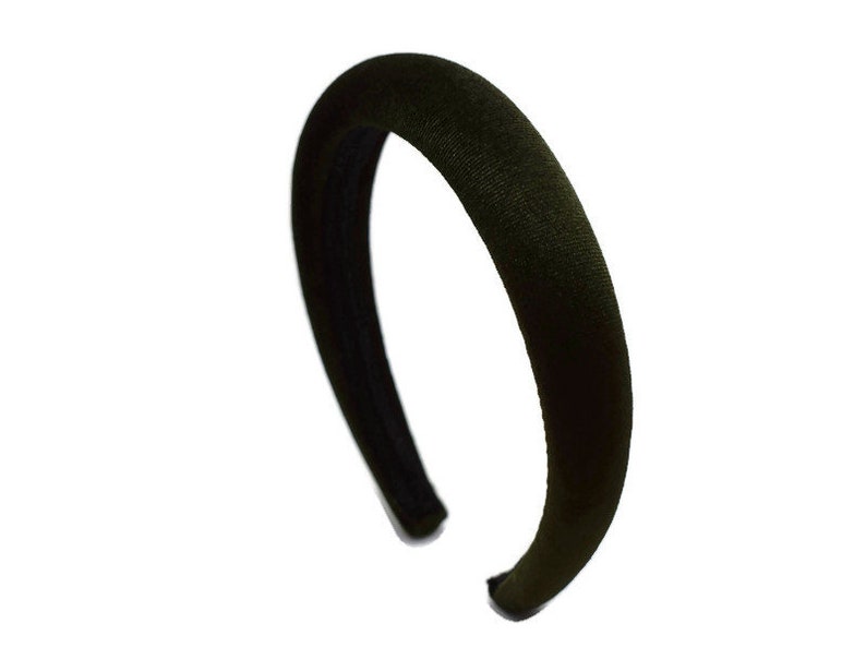 May include: A black velvet headband. The headband is wide and has a smooth, soft texture.
