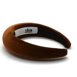 May include: A brown velvet headband with the text "viva la handmade" and a crown logo.