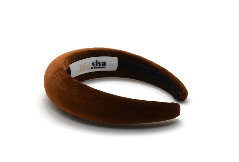 May include: A brown velvet headband with the text "viva la handmade" and a crown logo.