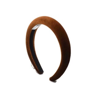 May include: A brown velvet headband with a black elastic band.
