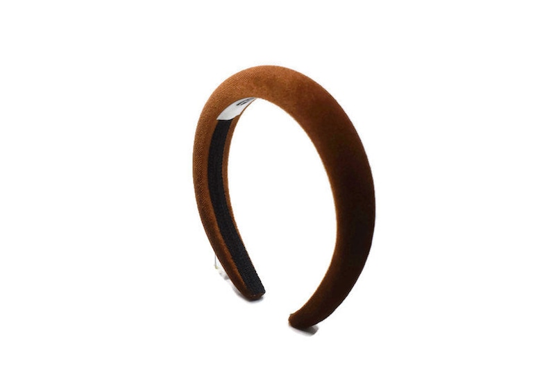 May include: A brown velvet headband with a black elastic band.