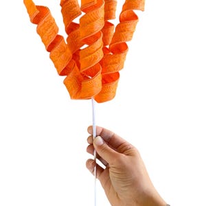 May include: A bunch of orange curly ribbon with a white stem. The ribbon has a textured pattern.