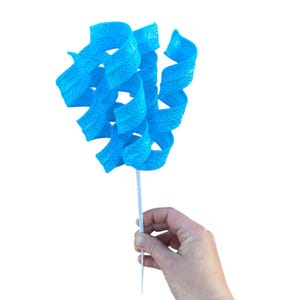 May include: A blue, curly, decorative flower with a white stem. The flower is made of plastic and has a textured surface.
