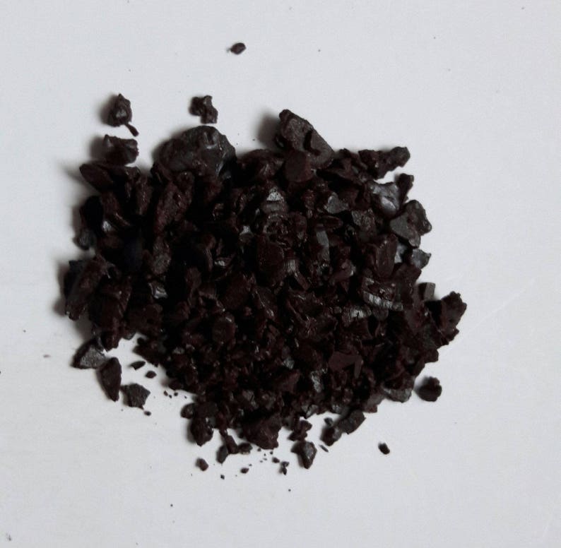 May include: A pile of dark brown coffee grounds.