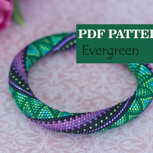 May include: PDF pattern for a beaded bracelet with a green, purple, and black geometric design. The pattern is called "Evergreen".