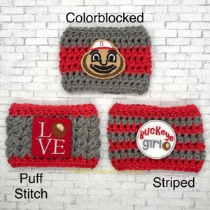 May include: Three handmade crochet coffee cup sleeves in gray and red. One sleeve features a colorblocked design with a mascot patch. Another has a red patch with the word "LOVE" and a football. The third has a "Buckeye Girl" patch.