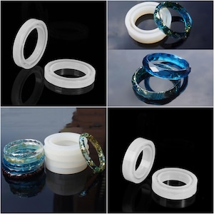 Peut inclure: Plusieurs moules à bagues en résine et des bagues finies. Les moules sont blancs et translucides, tandis que les bagues présentent diverses couleurs et motifs, notamment bleu, vert et or, avec des paillettes et des facettes géométriques. Les bagues sont sur un fond noir.