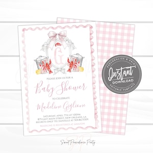 May include: A baby shower invitation with a pink scalloped border and a watercolour illustration. The invitation features a crest with a letter "G", crawfish, and the text "Baby Shower". Includes the text "Instant Download".