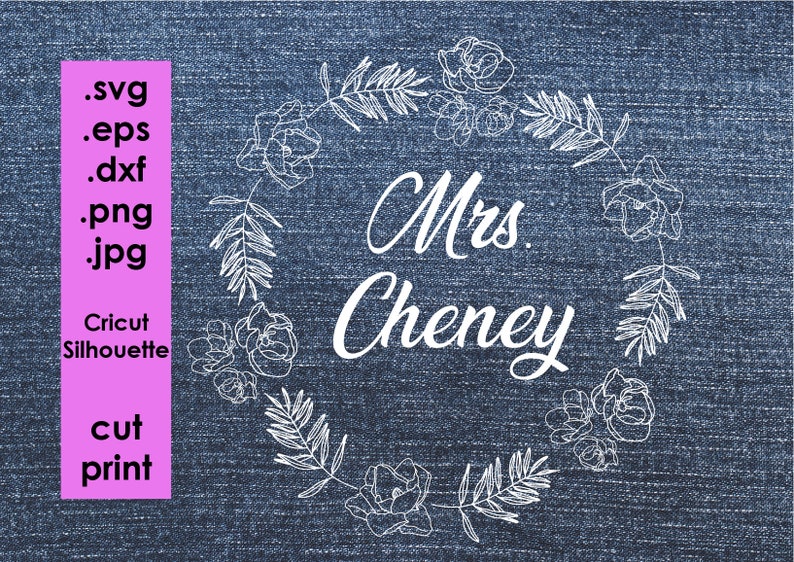 May include: White outline of a floral wreath with the text "Mrs. Cheney" in the centre on a blue denim background.