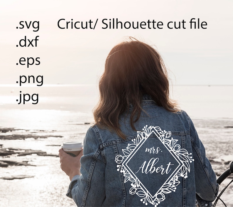 May include: A denim jacket with a white floral design and the text "mrs. Albert" in a diamond shape.