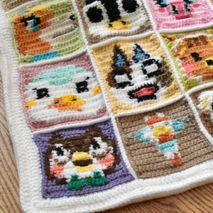 May include: A crocheted blanket with a variety of colorful animal faces. The blanket is made of white yarn with different colored squares featuring animal faces. The animals include a bird, a cat, a dog, a squirrel, and a fish.