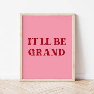 Puede incluir: Un p&oacute;ster rosa enmarcado con el texto "IT'LL BE GRAND" en rojo.