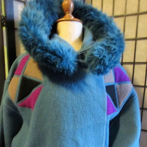 full length blue boiled wool coat, removeable hood with faux fur, unlined, pockets, geometric applique, versatile weather wear, classic