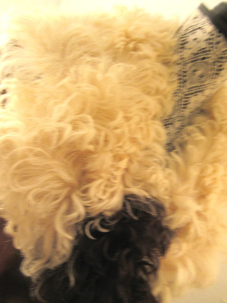 May include: A fluffy white and brown sheepskin rug with a soft, shaggy texture.