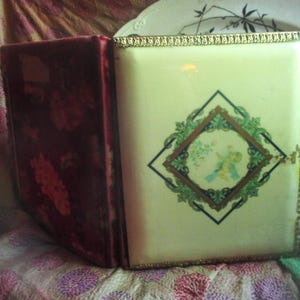 antique cabinet card photograph album, creamy celluloid decorative cover, red velvet back, working latch, some photos, standard !800&#39;s wear,