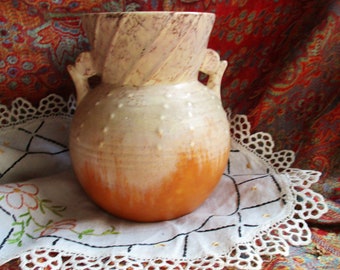 art deco art pottery made in England, round belly, trumpet neck, creamy mottled beige, with amber toned bottom, 2 handled, raised design