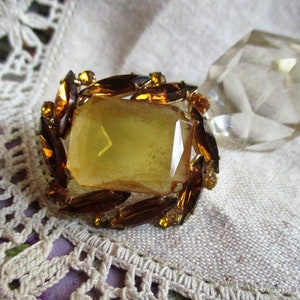 mid century amber rhinestone brooch, large center amber glass, dark amber navettes surround, tasteful and bold, dress up or down