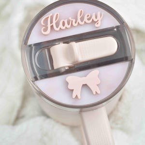 a close up of a hair dryer with two hair clips