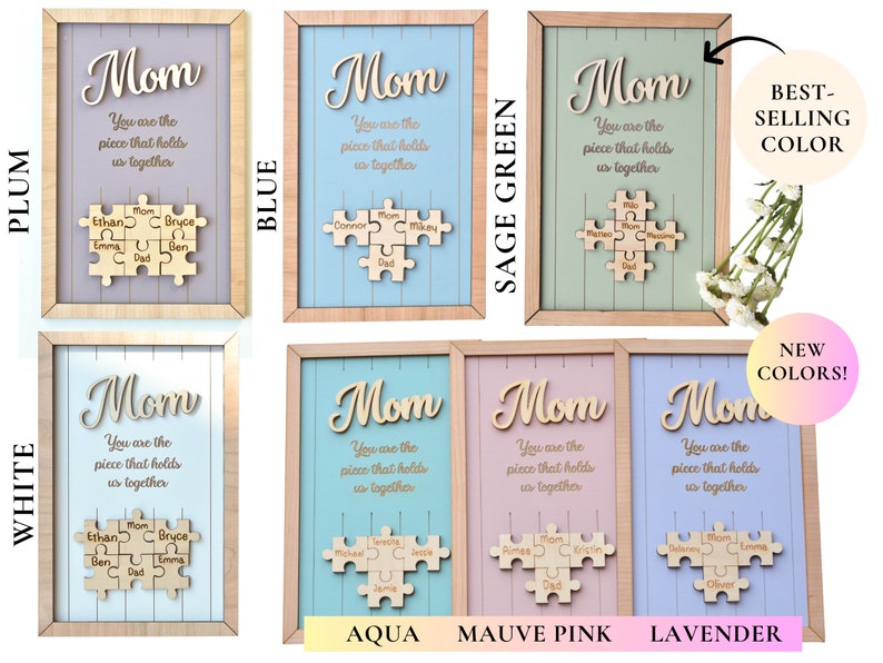 Puede incluir: Arte de pared enmarcado en madera con la palabra "Mom" en cursiva, la frase "You are the piece that holds us together" y un rompecabezas de madera con nombres. Disponible en ciruela, azul, verde salvia, blanco, aguamarina, rosa malva y lavanda.
