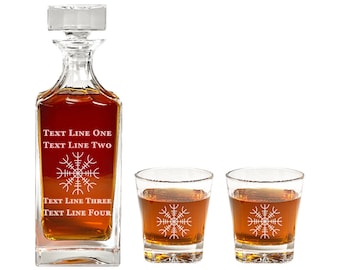 May include: A crystal decanter and two matching glasses with a decorative etched design. The decanter has the text "TEXT LINE ONE TEXT LINE TWO TEXT LINE THREE TEXT LINE FOUR" etched on the front.