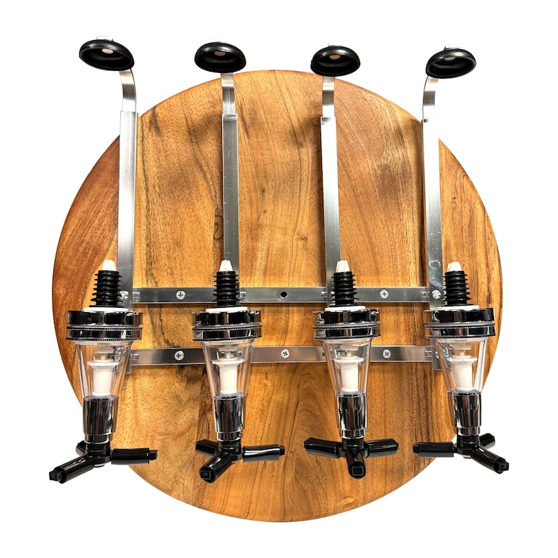 May include: A wooden wall-mounted liquor dispenser with four chrome liquor bottles and black spouts. The dispenser has a round wooden base and metal brackets.