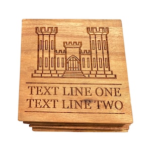 May include: A set of wooden coasters with a laser-engraved image of a castle and the text "TEXT LINE ONE TEXT LINE TWO".