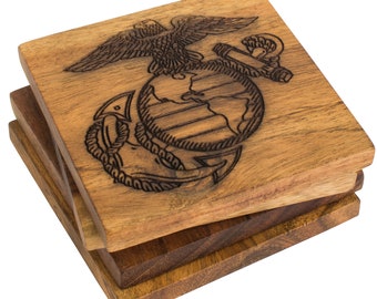 May include: Set of three wooden coasters featuring a brown wood finish with a laser-etched design of the United States Marine Corps emblem.