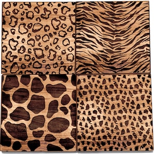 May include: Four square wooden tiles with different animal print designs. The tiles feature a leopard print, zebra print, giraffe print, and a smaller spotted print.