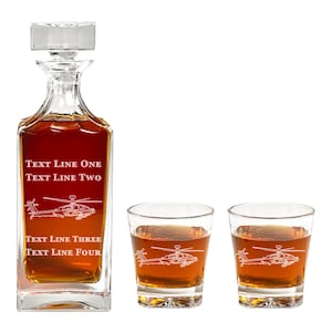 May include: A set of three clear glass decanter and glasses with an etched design of a helicopter. The decanter has the text "TEXT LINE ONE TEXT LINE TWO TEXT LINE THREE TEXT LINE FOUR" on the front.
