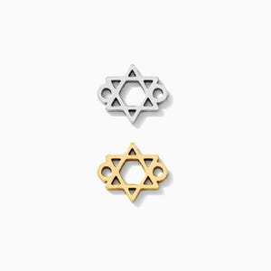 May include: Two Star of David charms. One is silver-colored, the other is gold-colored. Each charm has a six-pointed star design with small loops on each side. The charms are displayed on a white background.