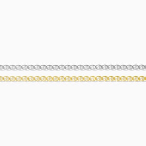 May include: Two delicate chain necklaces, one silver-colored and the other gold-colored, are displayed against a white background. The chains have a classic mariner link design, with each link resembling a small oval. The chains are parallel to each other.