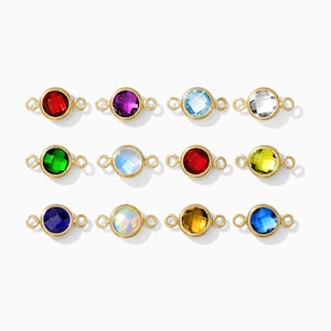 May include: Twelve gold-coloured gemstone connectors in a variety of colours, including red, purple, blue, green, and yellow. Each connector has a small loop on either side for attachment. The gemstones are round and faceted.