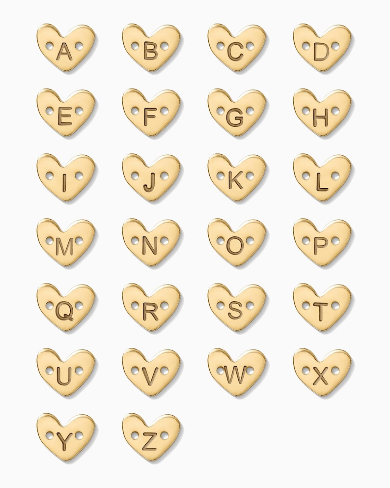 May include: Gold heart-shaped charms with letters A through Z. Each charm has two small holes for attaching to a necklace or bracelet.