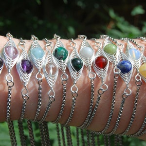 May include: A set of 12 silver wire wrapped bracelets with different coloured gemstone beads. Each bracelet features a delicate chain and a unique gemstone bead.