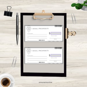 May include: A clipboard with two "Bank of Prosperity" checks, featuring an eye design and space for dollar amounts. A black pen, paper clips, and a cup of coffee are also visible.